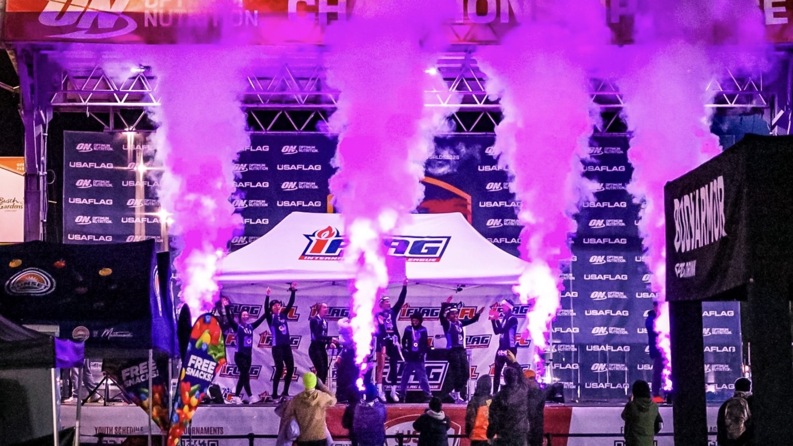 Sponsor signage surrounding the stage at an International Flag League championship event